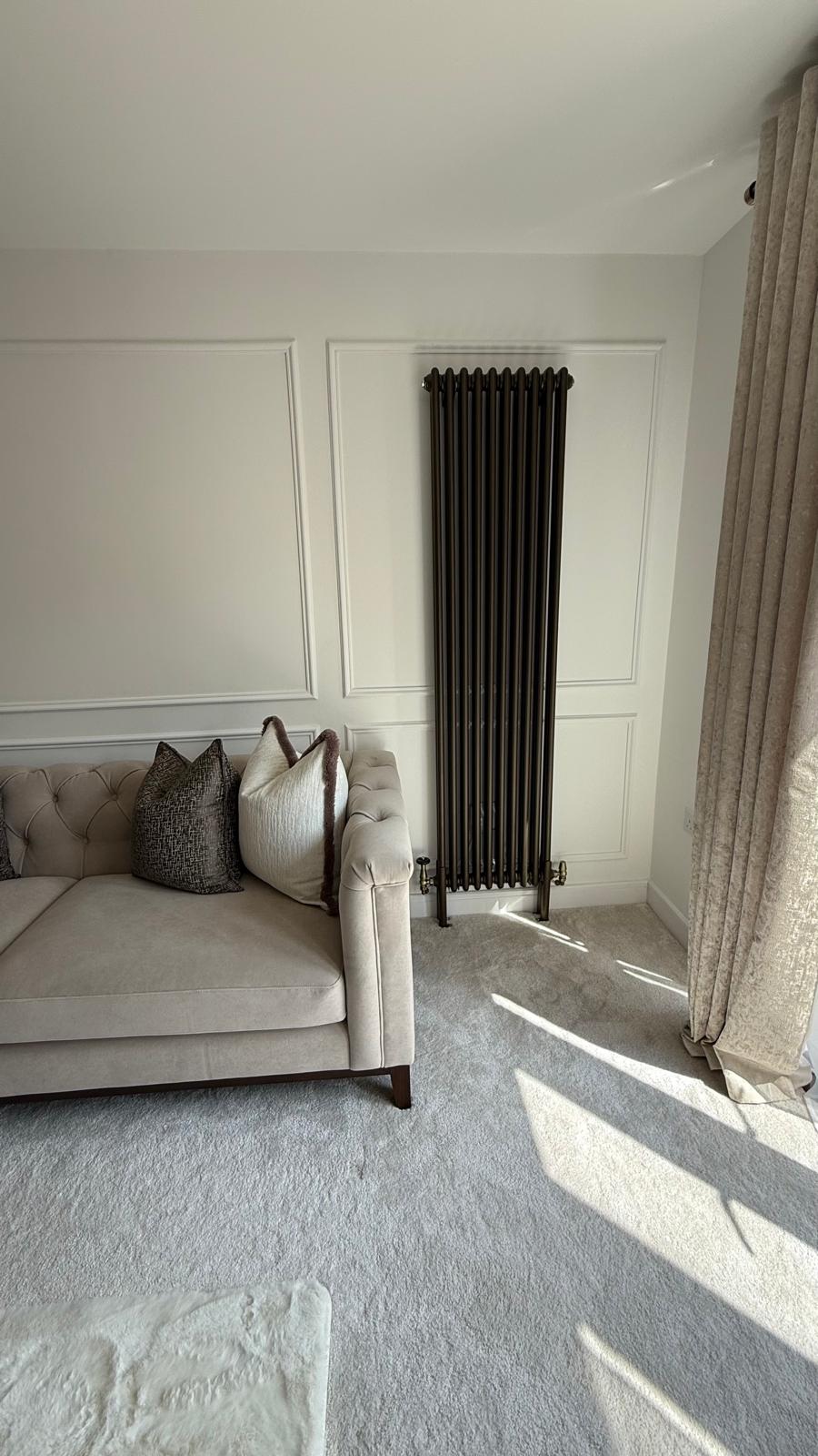 Designer radiator in living room next to sofa in Bloxwich property