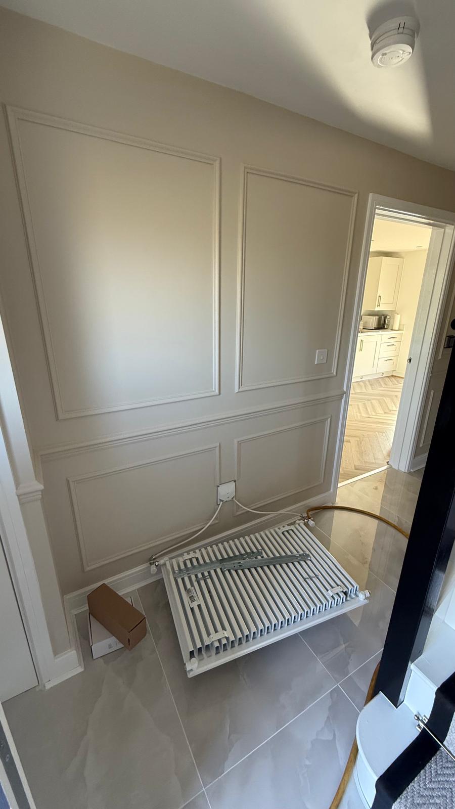 Old radiator removed and placed on the floor before replacement in Bloxwich