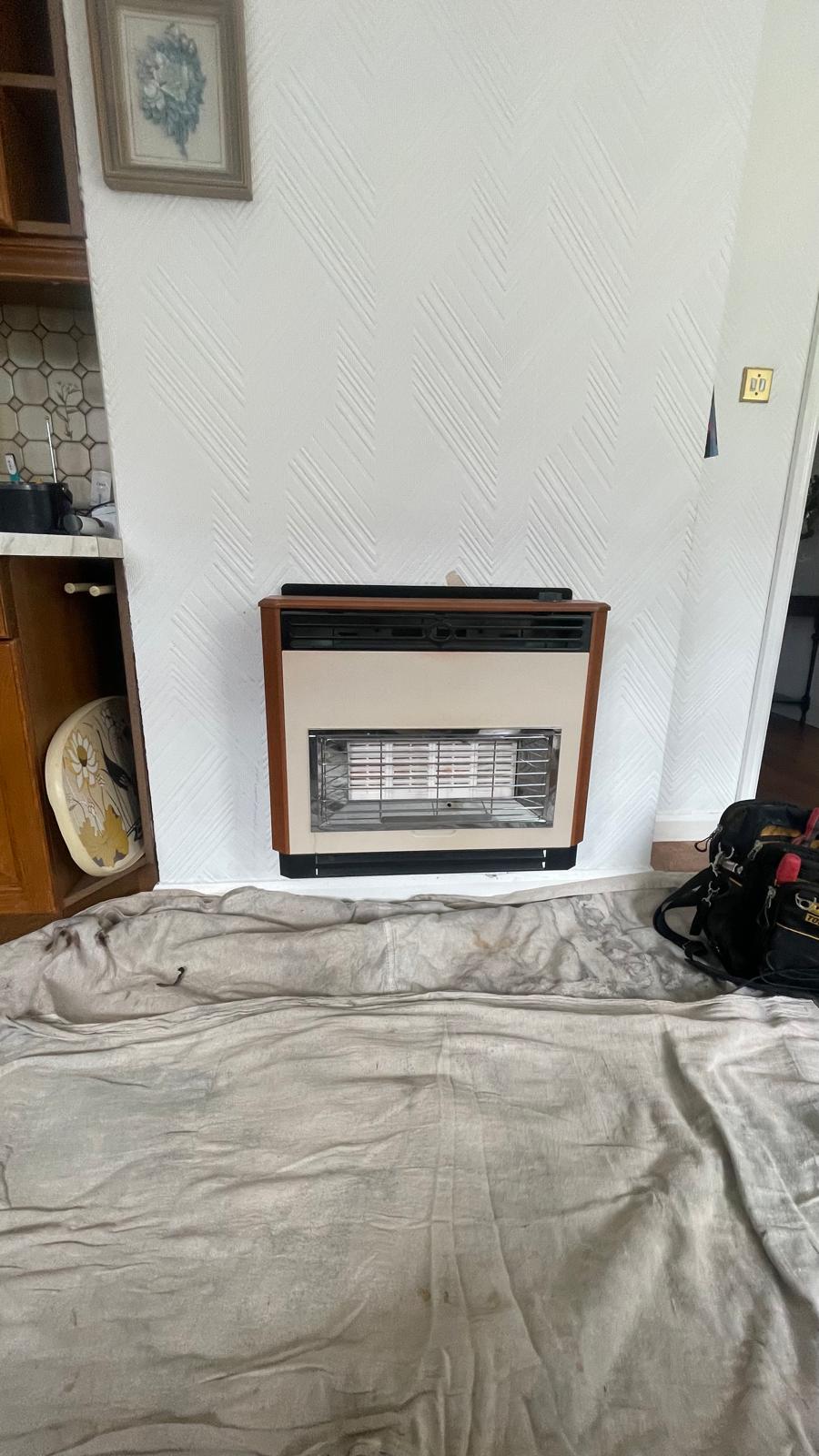 Old gas fire in fireplace before removal in Wednesbury property