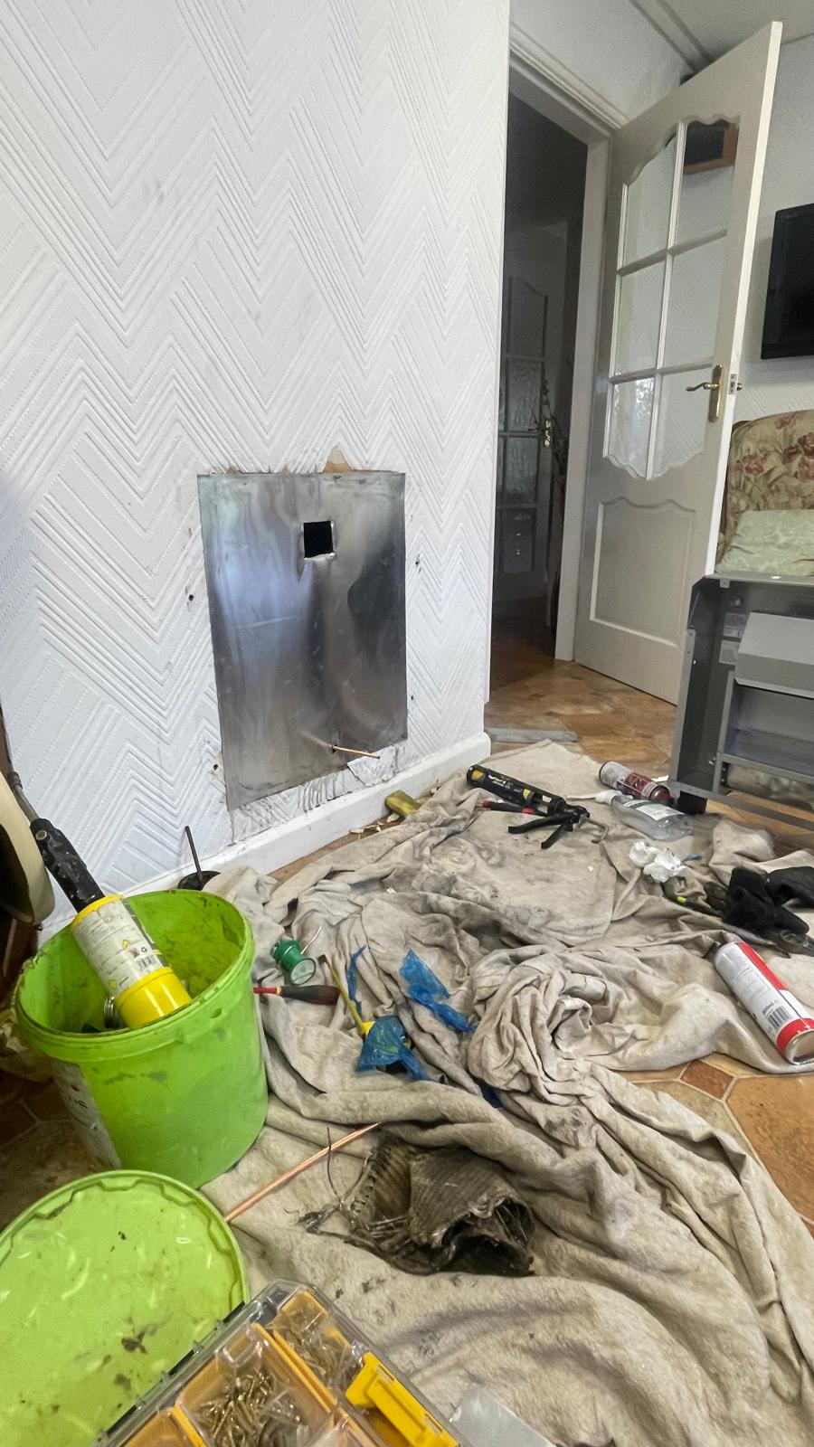 Metal closure plate fitted into the fireplace opening ready for new gas fire