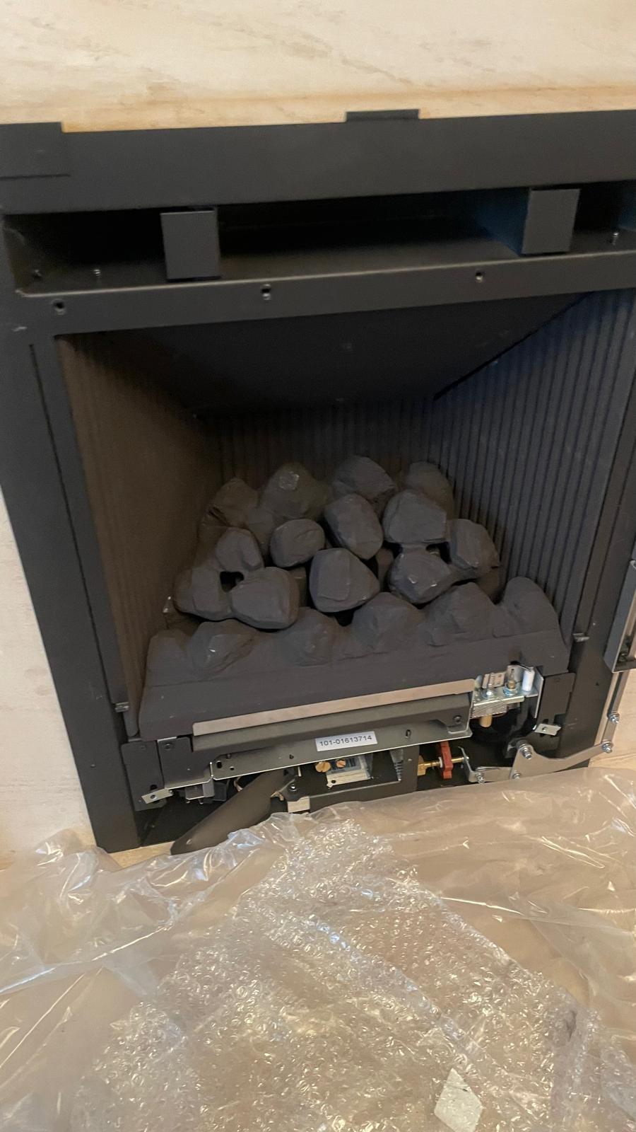 New gas fire being fitted into fireplace in West Bromwich