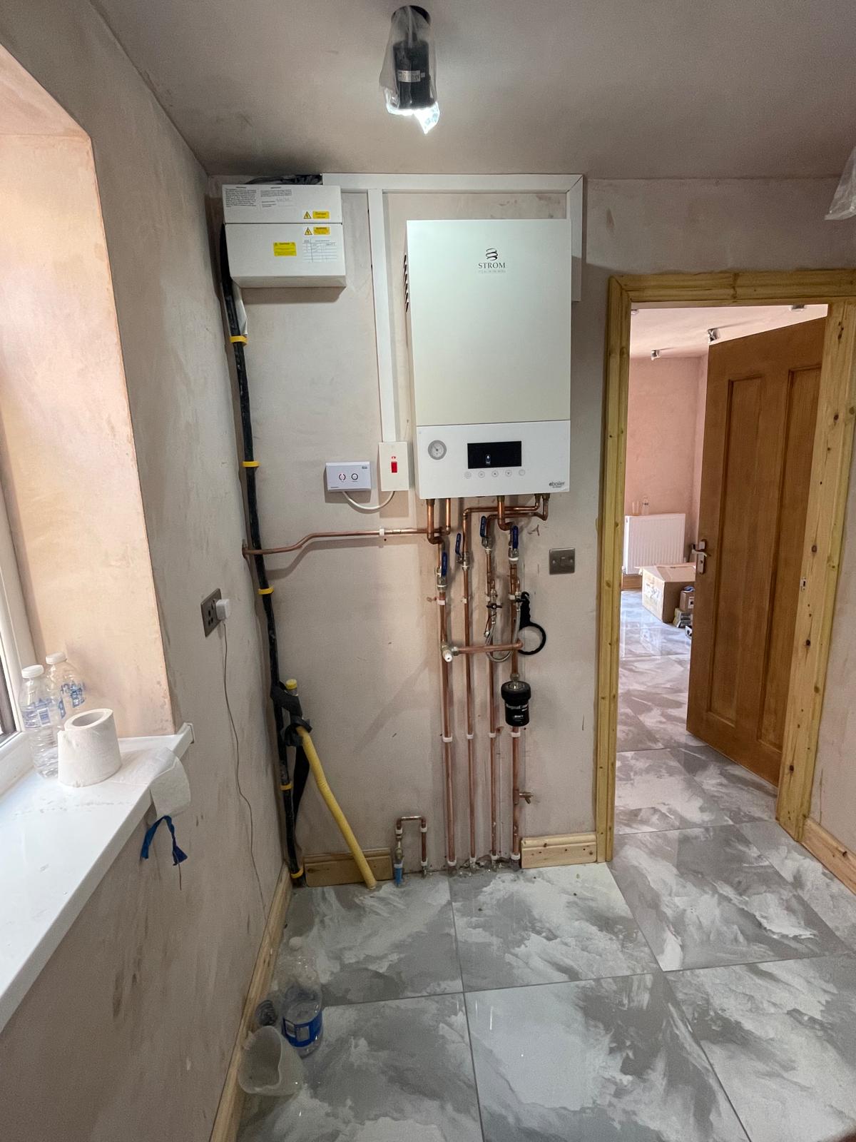 Full room view of Strom electric boiler installation in utility area in Wolverhampton