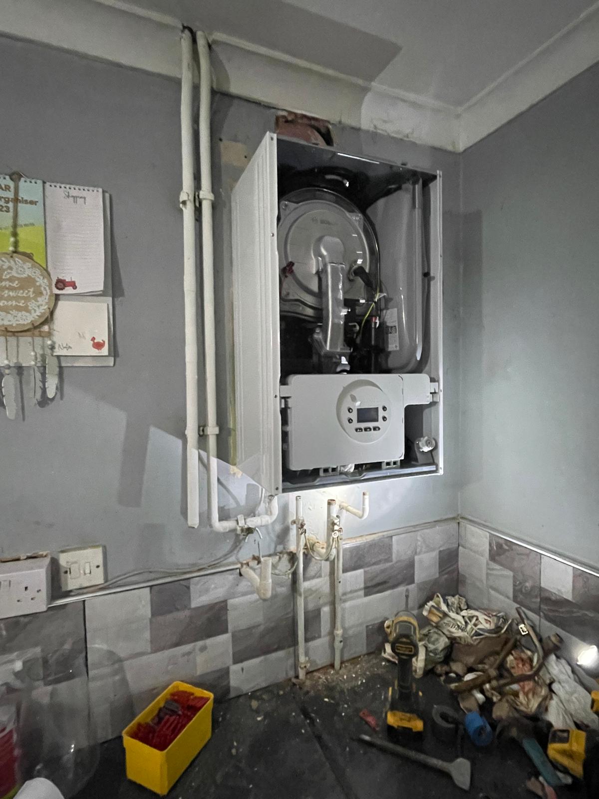 Worcester 1000 boiler with casing open during installation showing internals and digital controller