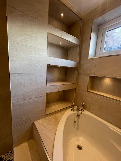Toilet and green herringbone tiles with patterned floor