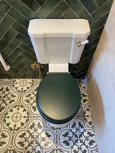 Corner bath with lit recessed niches and gold fixtures