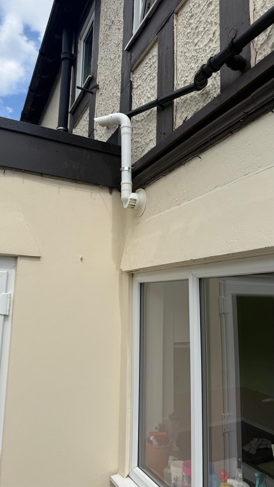 Extended flue routed through wall for safe ventilation
